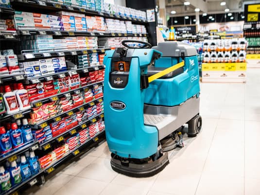 Autonomous robotic floor scrubber operating in an Albert supermarket aisle