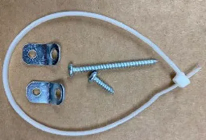 Recalled New Age furniture tip-over restraint kit with white plastic zip-ties and anchor straps